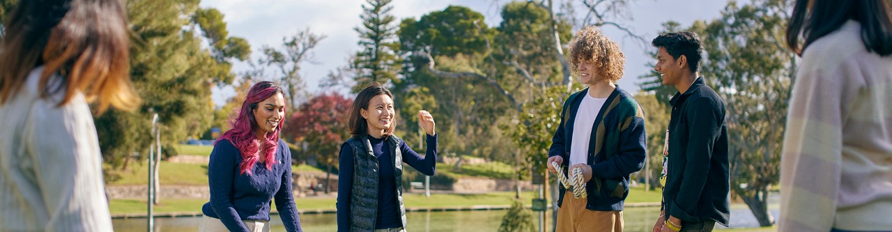International students socialising by River Torrens